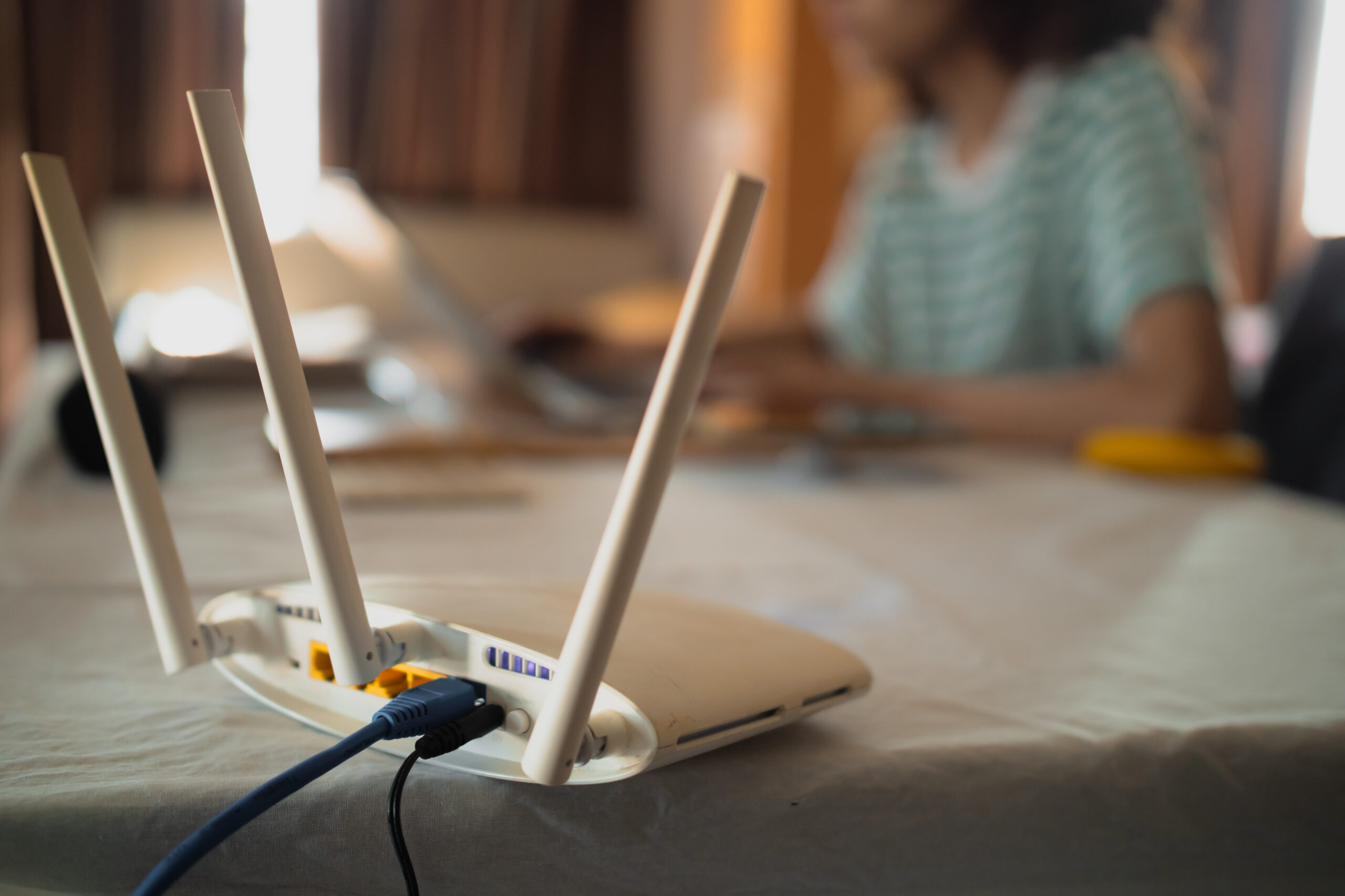 a woman is working at home using a modem router, connecting the